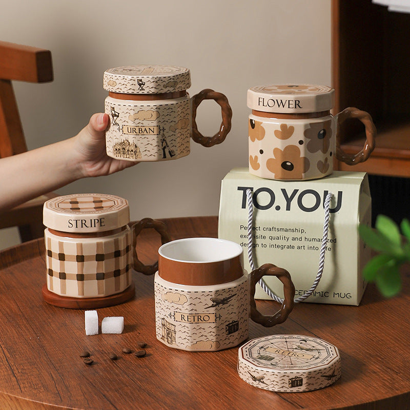 Decorative mugs with lids on a wooden table, featuring brand 'TO.YOU'.