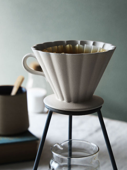 White ceramic coffee filter on a stand with a blurred background SHOP NOW