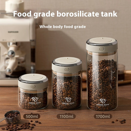 Three airtight, food-grade borosilicate glass coffee storage jars in 500ml, 1100ml, and 1700ml capacities, filled with whole coffee beans on a wooden countertop. BUY NOW