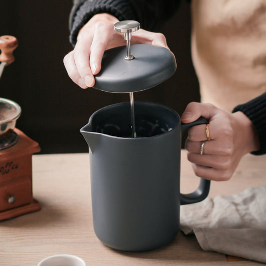 Preparing to brew coffee with a ceramic French press