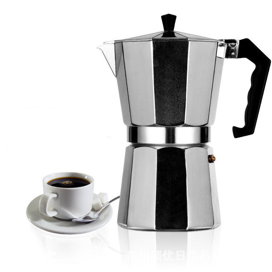 Stainless steel espresso maker with a cup of coffee