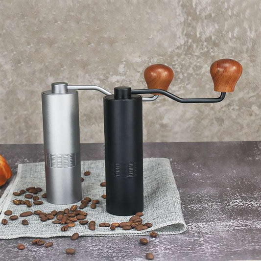 Black and silver manual coffee grinders with coffee beans – durable home coffee mill.