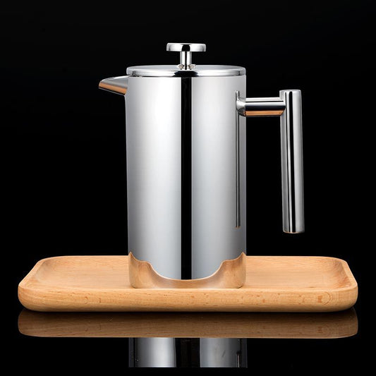 Stainless steel French press on a wooden tray with a black background