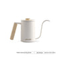 White hand brewing kettle with wooden handle on a white background