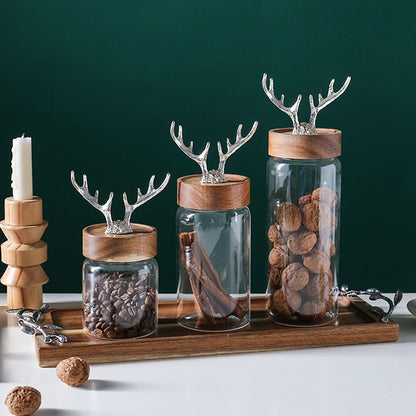 Decorative glass jars with wooden lids and antler decorations