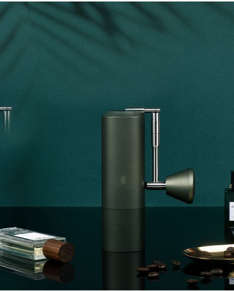 Olive green manual coffee grinder, close-up showing precision grinding mechanism and durable build. #CoffeeGrinding #QualityCoffee #CoffeeLoverGifts #BaristaAtHome #CoffeeAddict