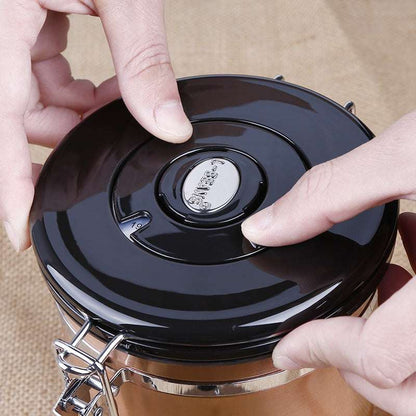 A close-up shot of hands adjusting the date tracker on the black lid of a coffee canister. Shop NOW