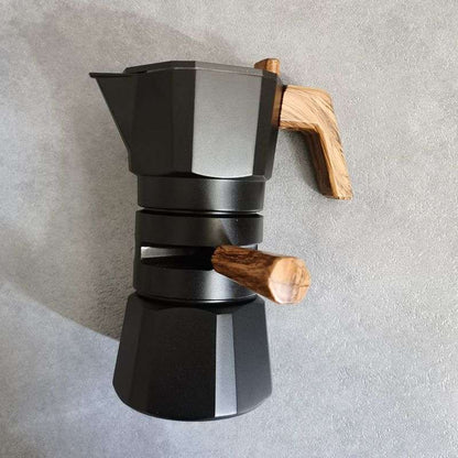 Matte black Hexagon Moka Pot. Modern stovetop espresso maker. Dark coffee pot with wooden handle.