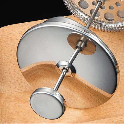 Close-up of a wooden and metal kitchen tool with a metallic lid and cylindrical components. Shop now free shipping