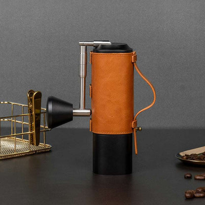 Premium manual coffee grinder with tan leather wrap and black base, ideal for home coffee brewing. #CoffeeGrinder #ManualCoffee #HomeBrew #CoffeeLover #KitchenEssentials