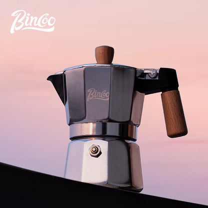 Close up of black moka pot spout and lid, showing high-quality design of the espresso maker.