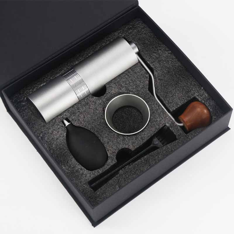 Premium silver manual coffee grinder gift set with cleaning accessories.