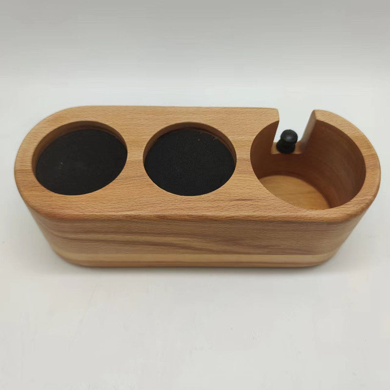A solid beechwood espresso tamping station with three circular slots and a portafilter holder. The station is designed to organize and hold coffee tools like a tamper, distributor, and a portafilter, preventing scratches on the countertop. Shop- now!