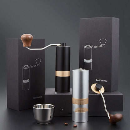 Premium manual coffee grinder set in matte black and silver with elegant packaging and accessories. Ideal for home baristas and coffee lovers.