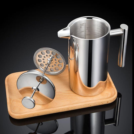 Stainless steel milk frother and wooden stand on a dark background
