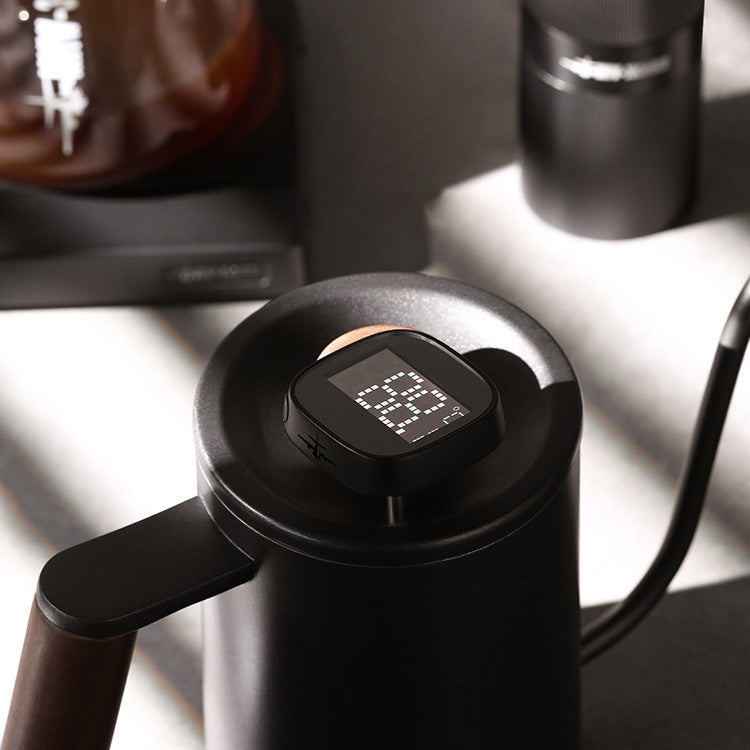 Digital coffee thermometer in a black gooseneck kettle, displaying a precise temperature of 88 degrees Celsius.