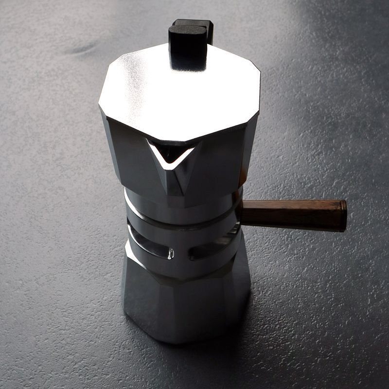 Assembled silver Hexagon Moka Pot. Stovetop coffee maker with wood handle. Home espresso brewer.