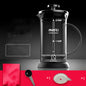 Black coffee maker with measurement markings on a dark background