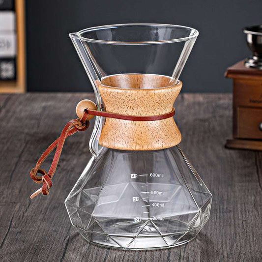 CHEMEX Full view of glass pour-over coffee brewer with wood collar and leather tie.