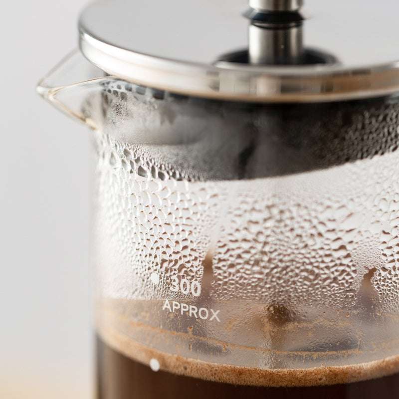 CAFEDE KONA French Press close-up of glass with 300ml marking. Durable heat-resistant glass. #CoffeeGadget #QualityCoffee #FrenchPressDetail