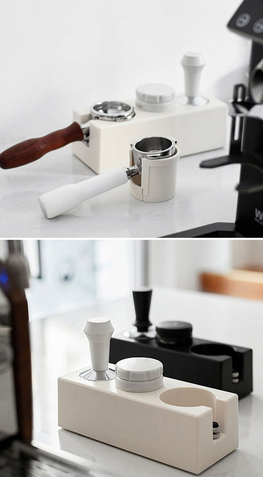 Coffee grinder and accessories on a white surface with a blurred background