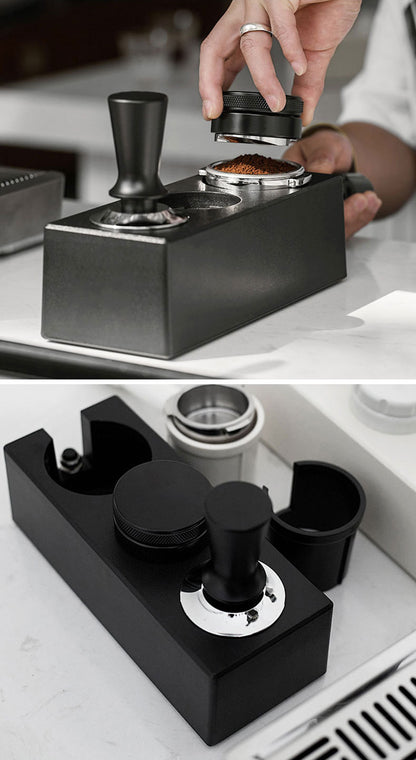 Coffee tamp being used on a black coffee tamp press with a close-up of the tamp mechanism.