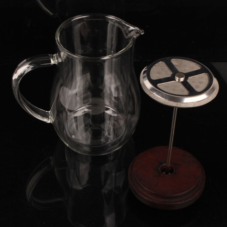Disassembled glass French press components: clear carafe, stainless steel plunger with rosewood knob. #CoffeeGear #BrewingTools