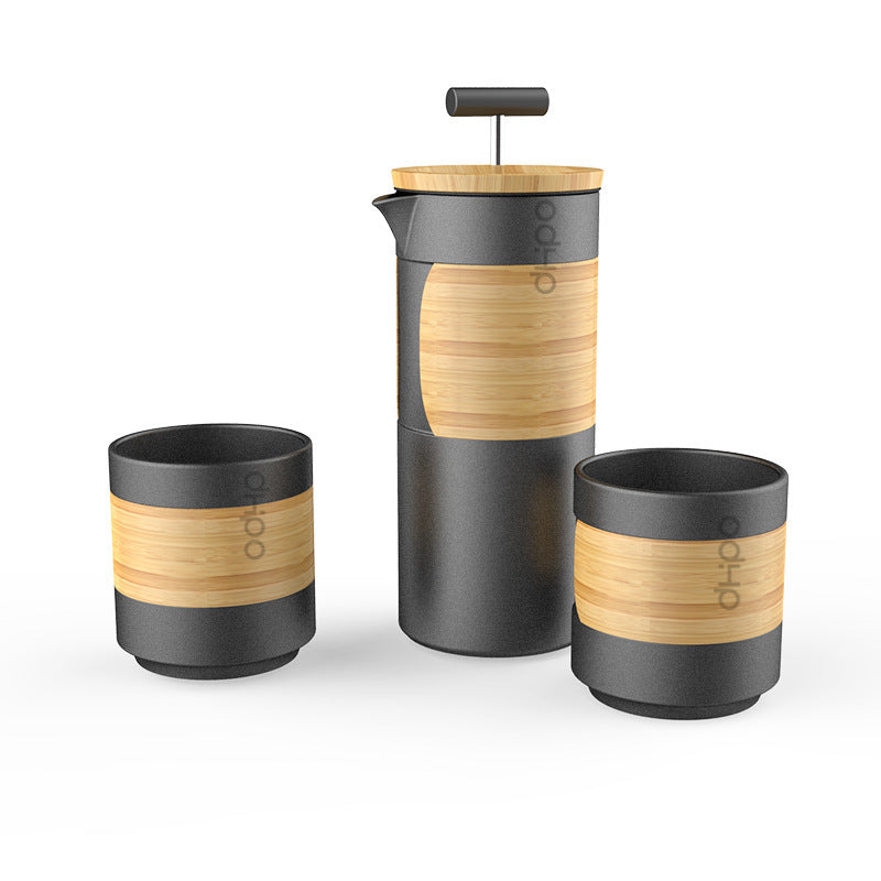 Bamboo and black coffee press and cups set on a white background