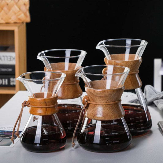 Four different sizes (400ml, 600ml, 800ml, 1000ml) of the glass pour-over coffee maker with wooden collars, lined up on a white table. SHOP NOW! FREE SHIPPING!