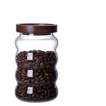 Glass jar with wooden lid filled with coffee beans Shop now!