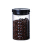 Hand holding a 600ml airtight glass canister for coffee beans, showing its measurements and sleek design. FREE SHIPPING






















