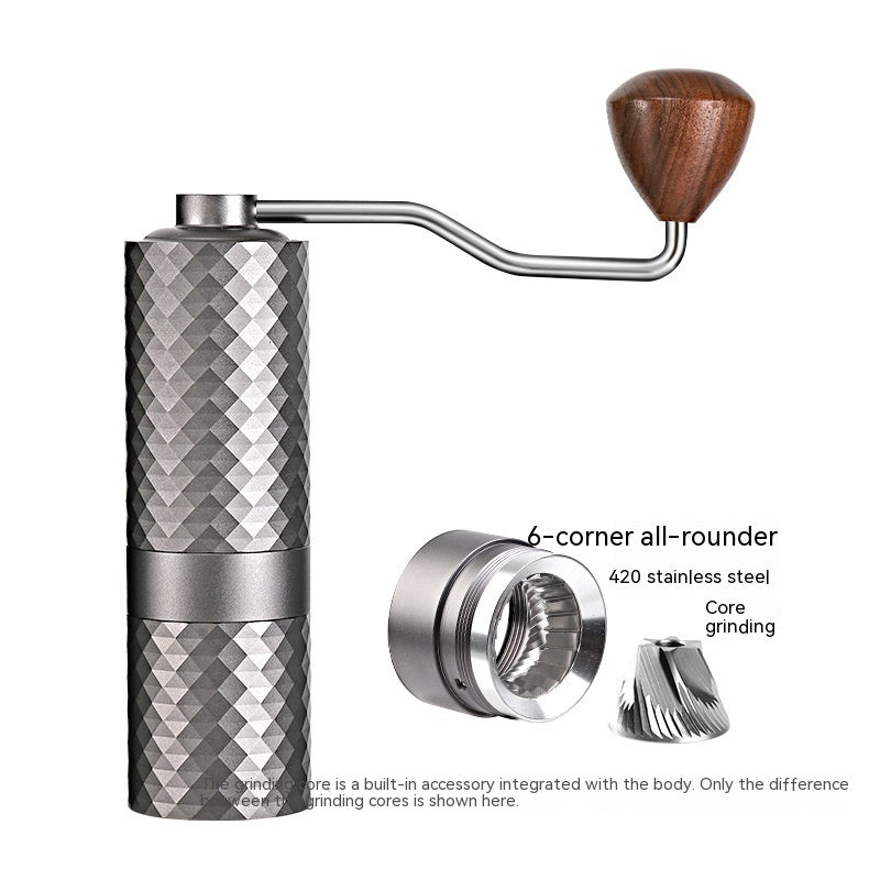 Manual coffee grinder with wooden handle and metallic body on a white background