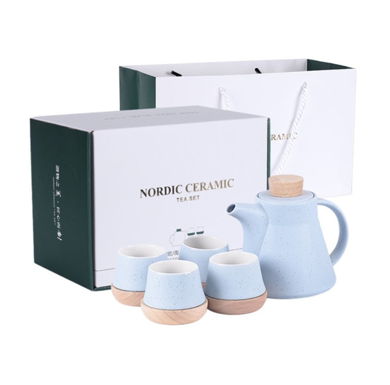 Nordic ceramic tea set with a teapot and four cups in light blue color