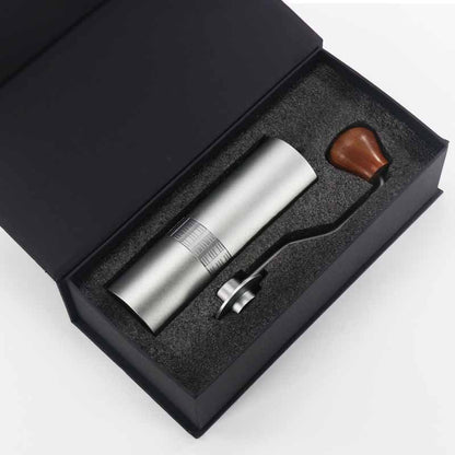 Silver manual coffee grinder in elegant gift box, perfect for home use.