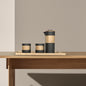 DOHO black ceramic coffee press and cups on wooden table, modern home decor, aesthetic coffee brewing, interior design.