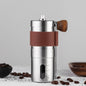 Stainless steel manual coffee grinder on counter with coffee beans, highlighting its modern design for home baristas.