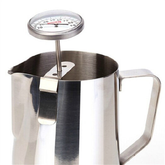 Milk frothing thermometer clipped to a pitcher, ready for steaming.