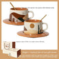 Two ceramic cups with saucers and spoons on a beige background, with packaging shown below.