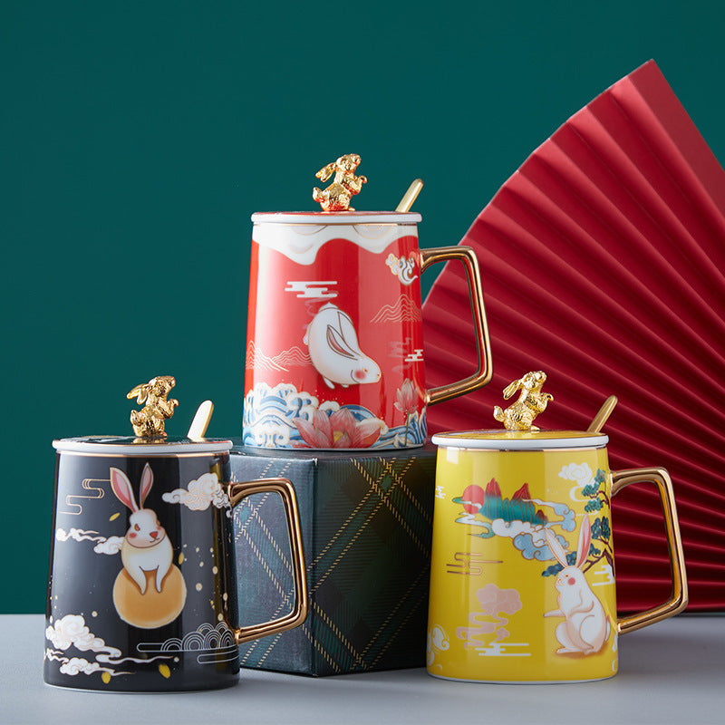 Set of four decorative mugs with animal designs on a green background