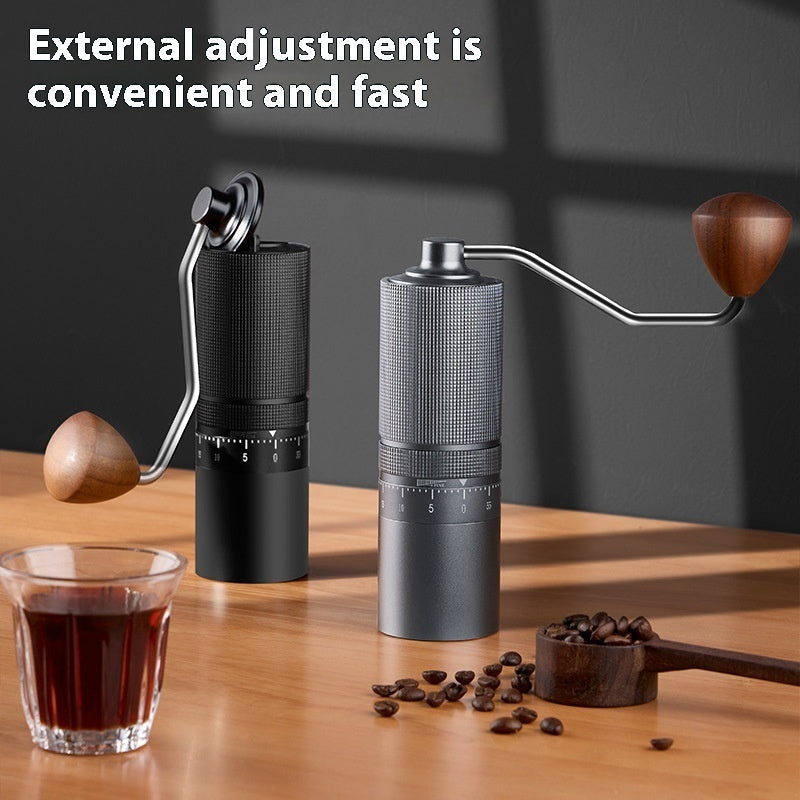 Black and gray manual coffee grinders on a wooden table with coffee, highlighting external grind adjustment for home brewing