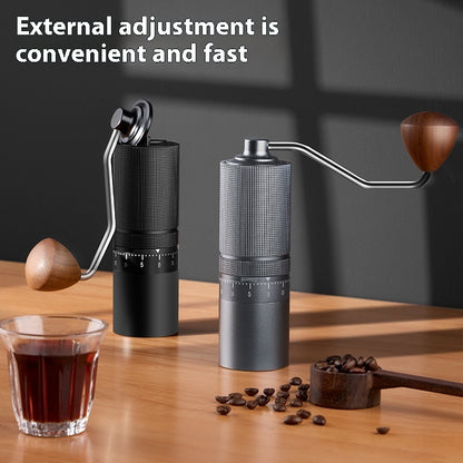 Black and gray manual coffee grinders on a wooden table with coffee, highlighting external grind adjustment for home brewing