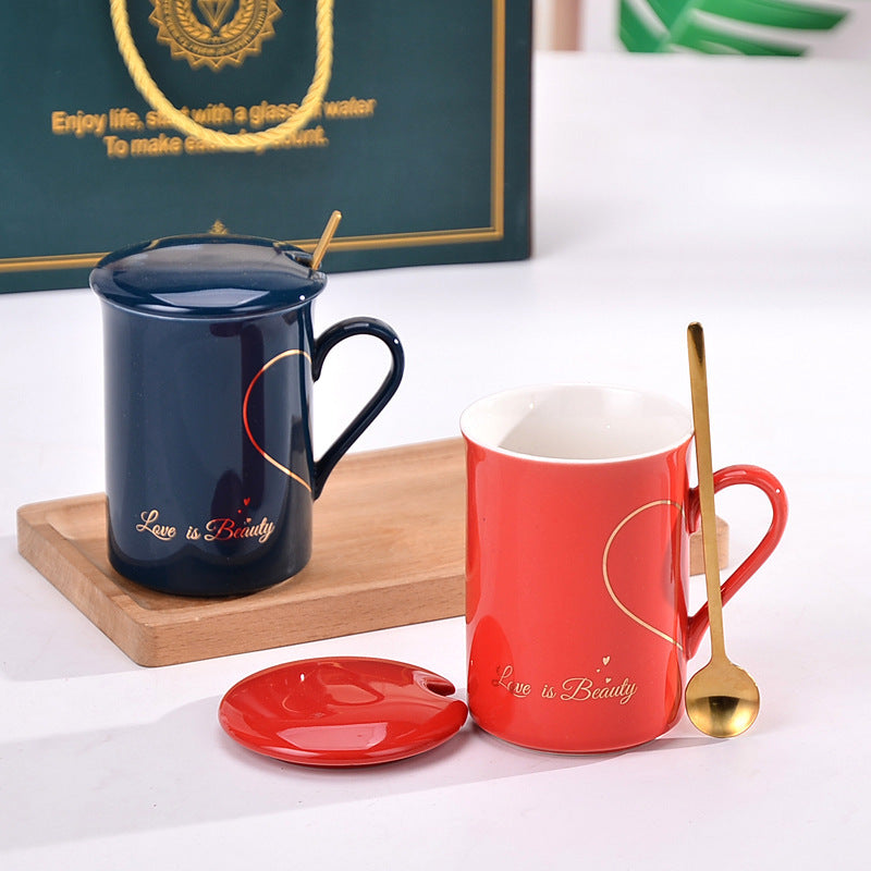 Two mugs, one blue and one red, with a spoon on a white surface.