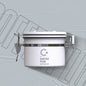 Close-up of a white Coffee Plus Breathing Canister, open to show dark roasted coffee beans inside. A one-way valve on the lid helps keep beans fresh.