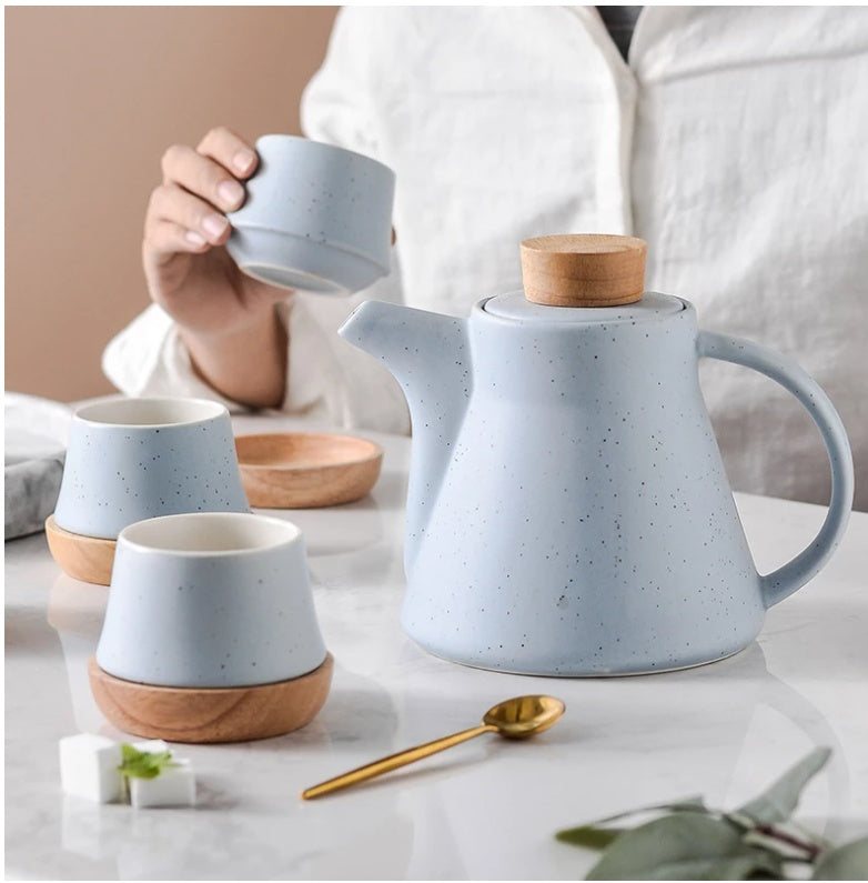blue ceramic mug with a matching teapot and cups on a marble