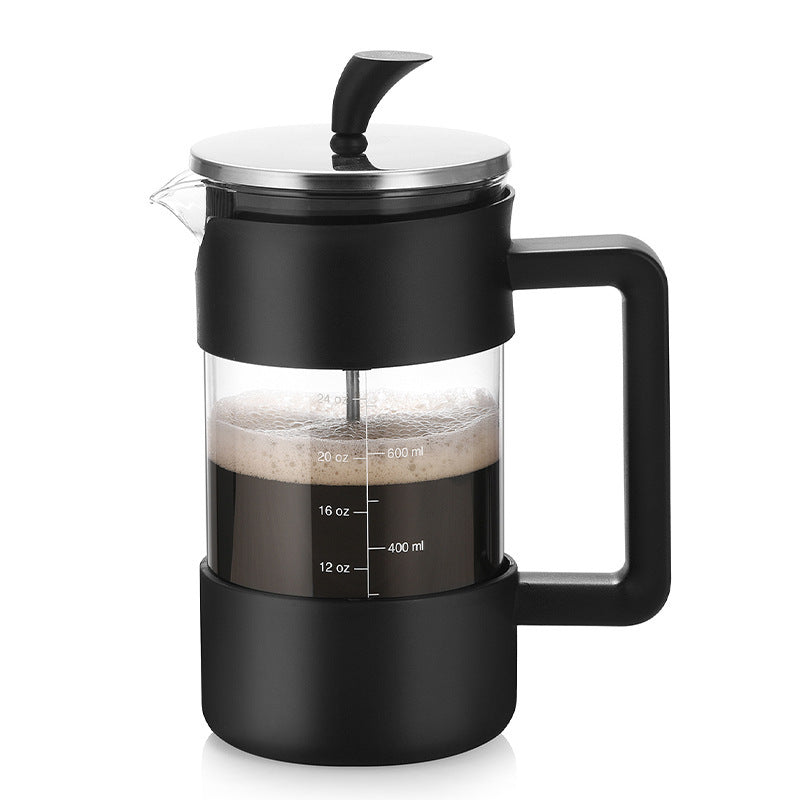 retaining plate), and the main glass carafe with black base and handle, marked with volume measurements (12 oz, 16 oz, 20 oz, 24 oz, and 400 ml, 600 ml).