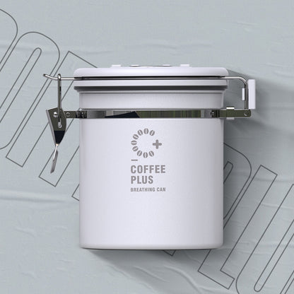  white Coffee Plus Breathing Canister, open to show dark roasted coffee beans inside. A one-way valve on the lid helps keep beans fresh.