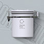  white Coffee Plus Breathing Canister, open to show dark roasted coffee beans inside. A one-way valve on the lid helps keep beans fresh.